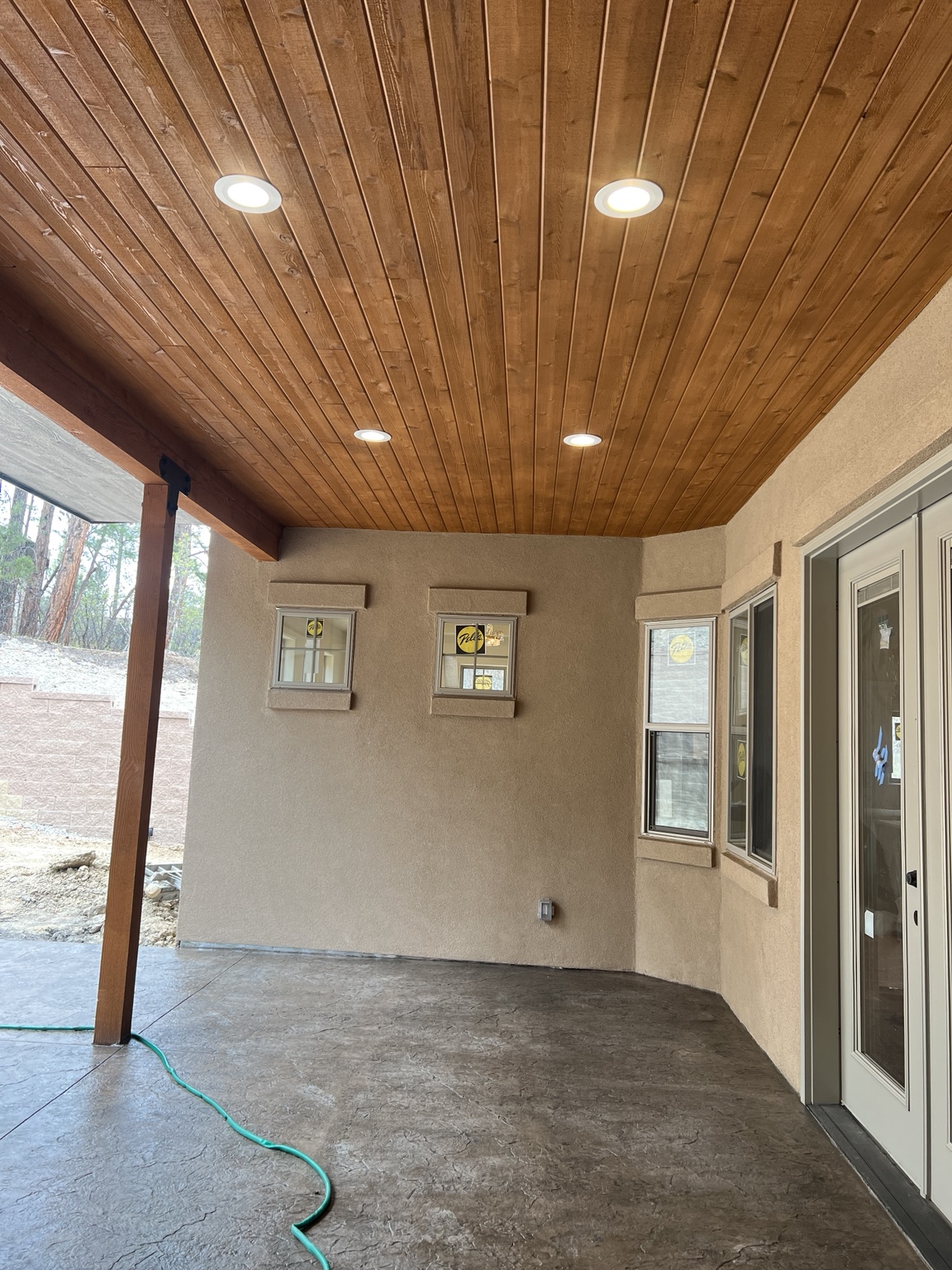 Recessed lights installed in a wood porch ceiling