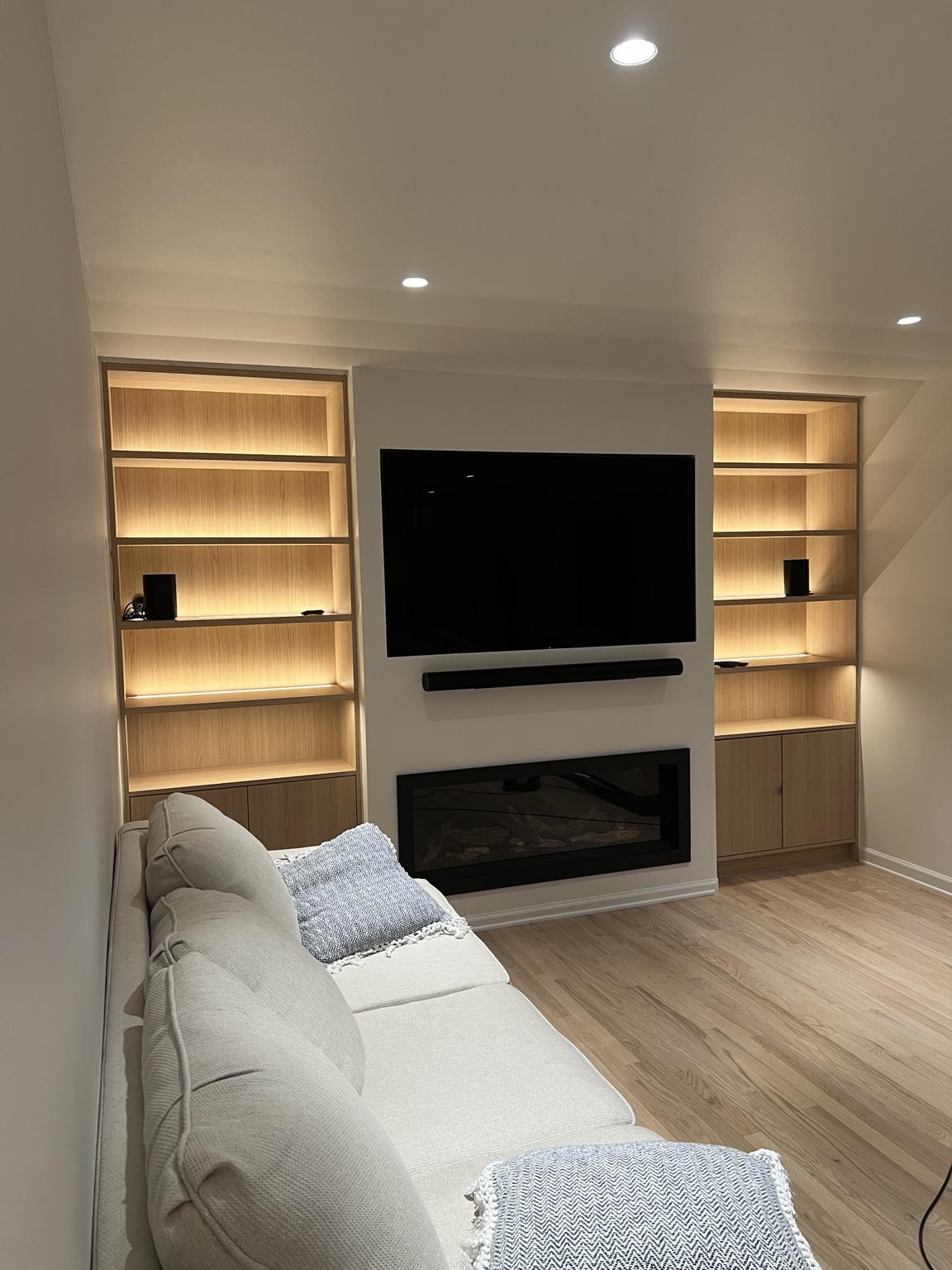 Built-in shelving with integrated LED lighting and recessed ceiling lights