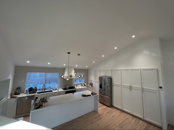 Finished kitchen with recessed lights and decorative pendant lighting