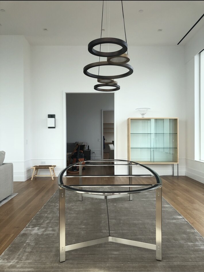 Modern ring chandelier installed in a high-ceiling residence